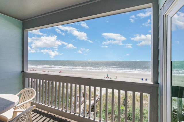 balcony featuring view of water and beach