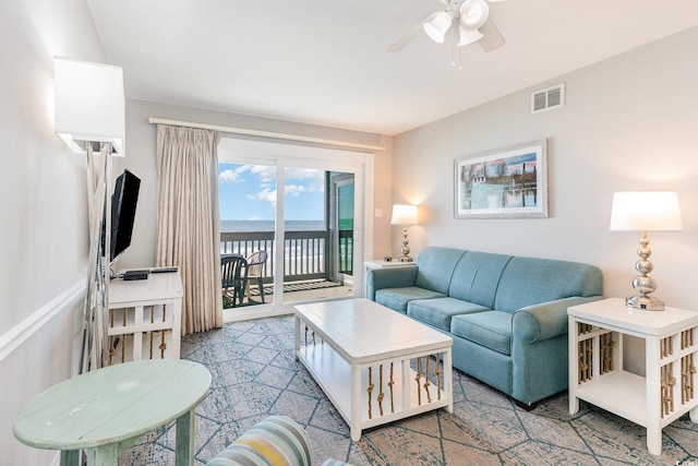 living area with ceiling fan