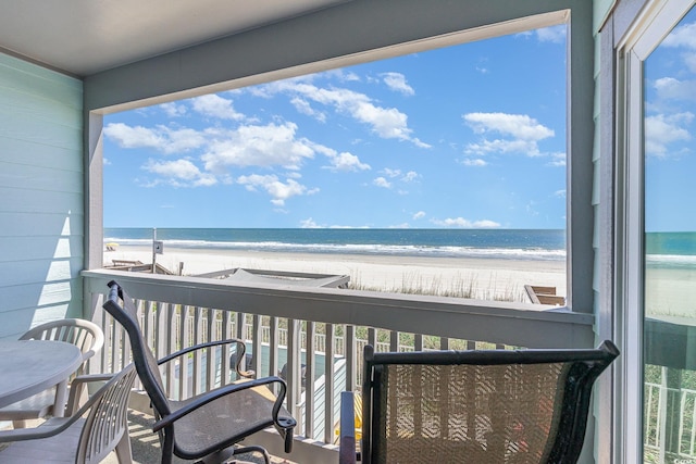 balcony with view of water and beach