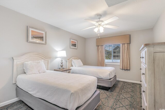 1011 S Ocean Blvd, Surfside Beach, SC 29575 - bedroom with baseboards and ceiling fan