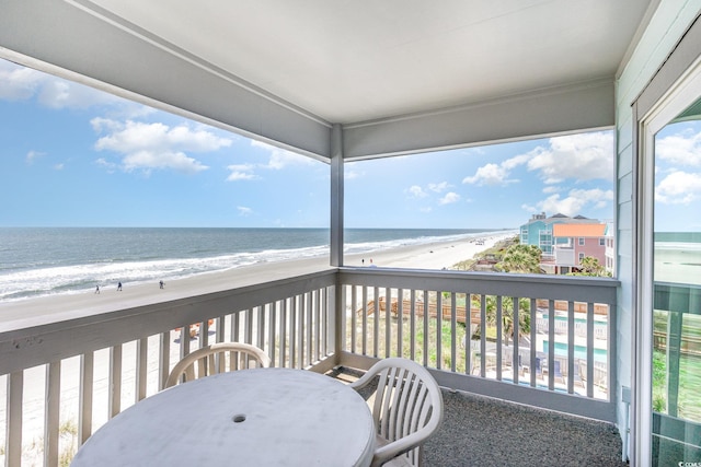balcony with view of water and beach