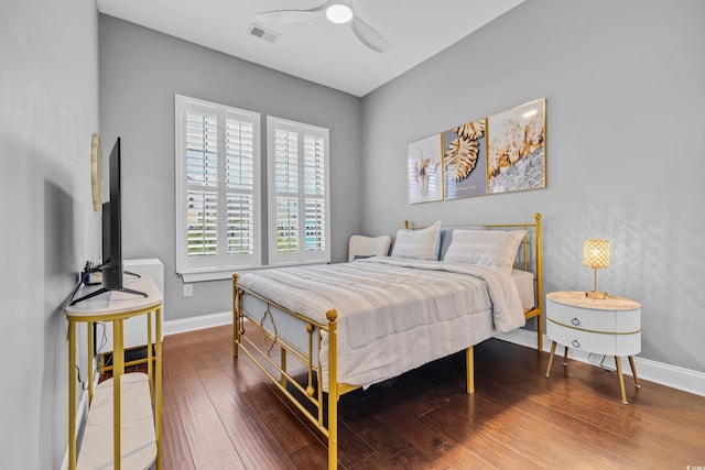 bedroom with baseboards, wood finished floors, and ceiling fan