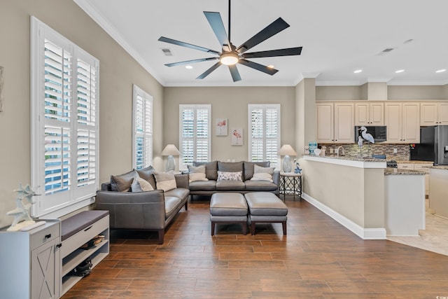 living area featuring dark wood-style flooring, ceiling fan, crown molding, recessed lighting, and baseboards
