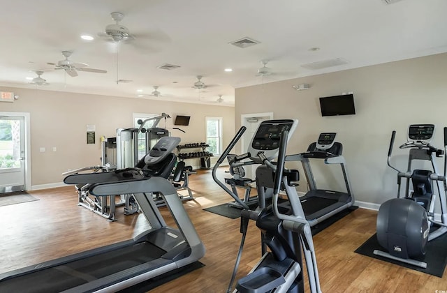 workout area with healthy amount of natural light, wood finished floors, baseboards, and recessed lighting
