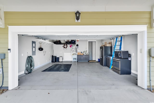 garage featuring freestanding refrigerator and electric panel