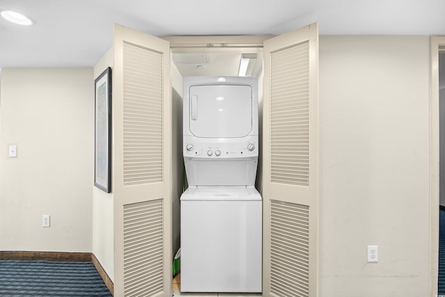 107 S Ocean Blvd Unit 1402, Myrtle Beach, SC 29577 - laundry room featuring stacked washing machine and dryer, baseboards, and carpet