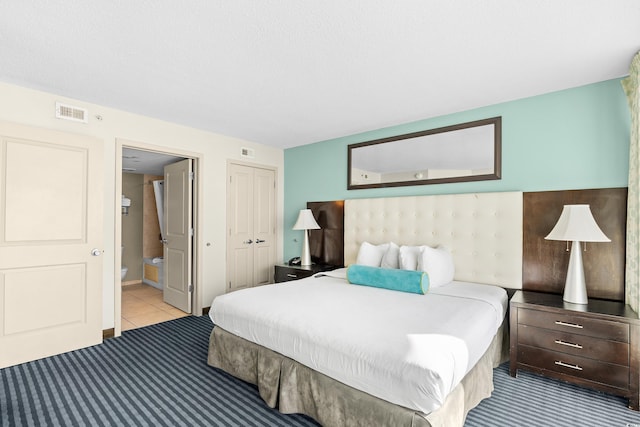 107 S Ocean Blvd Unit 1402, Myrtle Beach, SC 29577 - carpeted bedroom featuring a closet, connected bathroom, and tile patterned floors