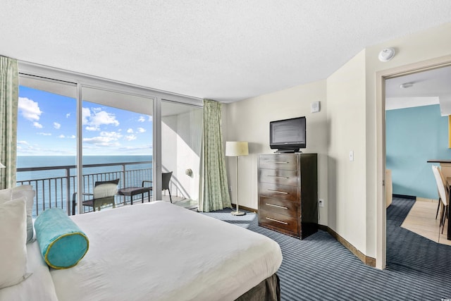 107 S Ocean Blvd Unit 1402, Myrtle Beach, SC 29577 - bedroom featuring expansive windows, a water view, access to outside, carpet, and baseboards