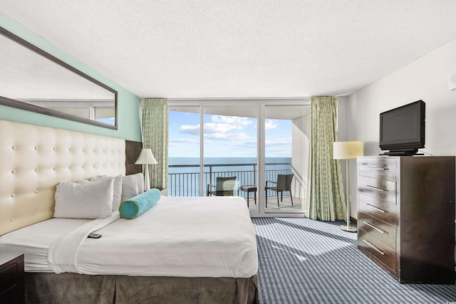 107 S Ocean Blvd Unit 1402, Myrtle Beach, SC 29577 - bedroom with a wall of windows, access to outside, carpet, a textured ceiling, and multiple windows