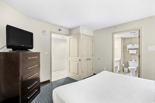 107 S Ocean Blvd Unit 1402, Myrtle Beach, SC 29577 - bedroom with ensuite bath, a closet, baseboards, and tile patterned floors