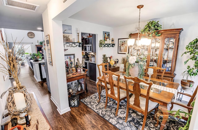 1147 Fairway Ln Unit 1147, Conway, SC 29526 - dining area with dark wood-style floors, baseboards, and a chandelier