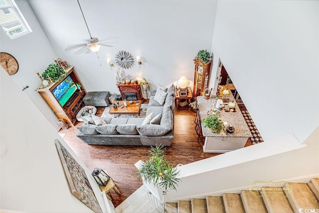 1147 Fairway Ln Unit 1147, Conway, SC 29526 - living room featuring ceiling fan, wood finished floors, a fireplace, and a towering ceiling