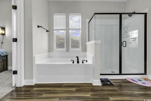 6239 Chadderton Cir, Myrtle Beach, SC 29579 - full bathroom featuring a bath, wood finished floors, a shower stall, and baseboards