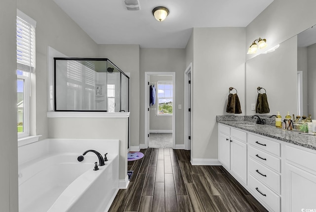 6239 Chadderton Cir, Myrtle Beach, SC 29579 - bathroom featuring a stall shower, vanity, a garden tub, wood finished floors, and baseboards