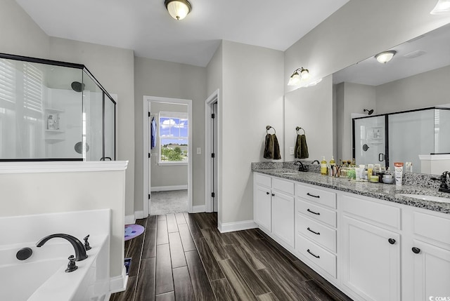 6239 Chadderton Cir, Myrtle Beach, SC 29579 - bathroom with a shower stall, double vanity, a garden tub, and wood finished floors