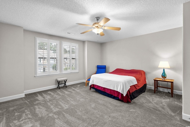 bedroom with carpet, a textured ceiling, baseboards, and ceiling fan