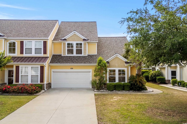 view of front facade with driveway, a garage, a shingled roof, and a front yard