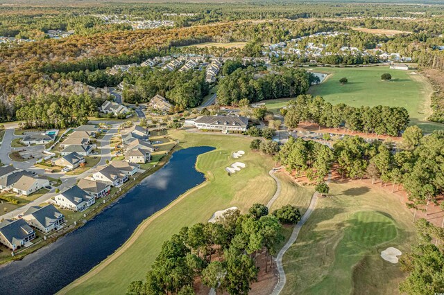 view of property location with a large body of water, nearby suburban area, and a golf club