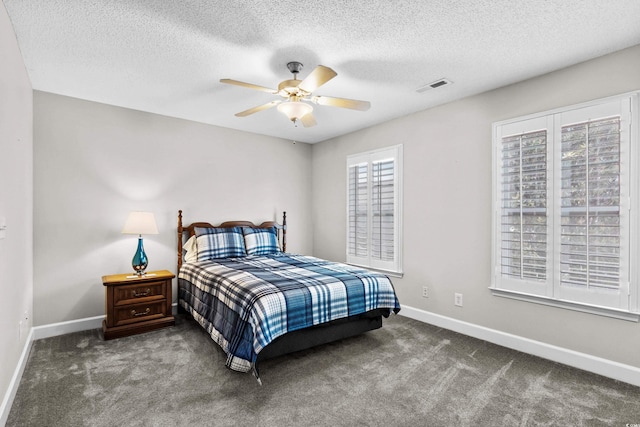 bedroom with baseboards, carpet, a textured ceiling, and ceiling fan