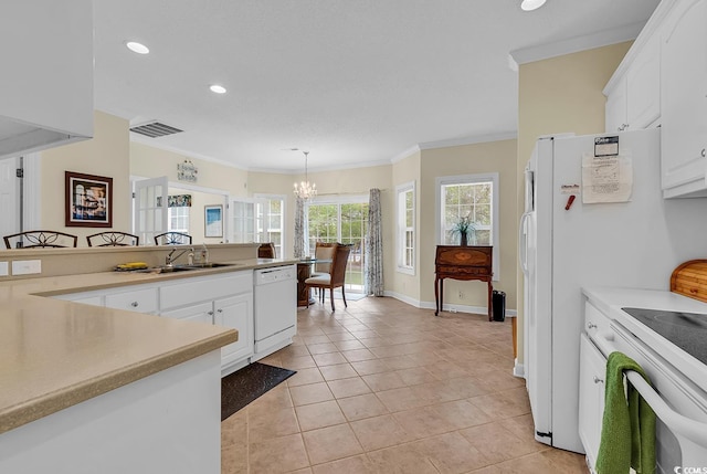 1729 Longleaf Dr, Myrtle Beach, SC 29575 - kitchen featuring white dishwasher, a chandelier, crown molding, white cabinets, and range