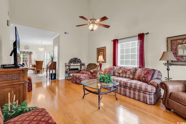 1729 Longleaf Dr, Myrtle Beach, SC 29575 - living room with light wood-style floors, a chandelier, a ceiling fan, and a high ceiling