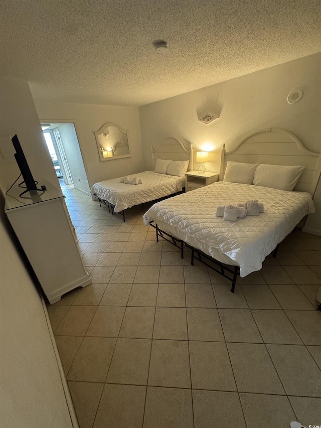 200 76th Ave N Unit 608, Myrtle Beach, SC 29572 - bedroom with light tile patterned floors and a textured ceiling