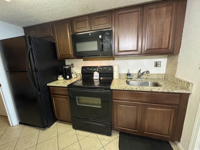 200 76th Ave N Unit 608, Myrtle Beach, SC 29572 - kitchen with black appliances, a sink, a textured wall, light tile patterned flooring, and light stone counters
