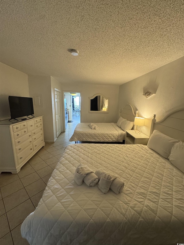 200 76th Ave N Unit 608, Myrtle Beach, SC 29572 - bedroom with a textured ceiling and tile patterned floors