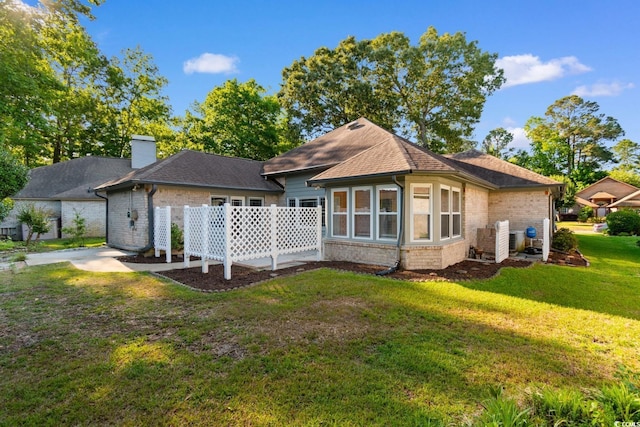 3107 Robyn Ct, Little River, SC 29566 - back of property featuring a yard, brick siding, a chimney, and roof with shingles