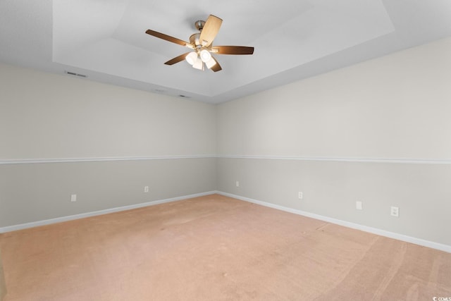 3107 Robyn Ct, Little River, SC 29566 - empty room with a tray ceiling, light carpet, ceiling fan, and baseboards