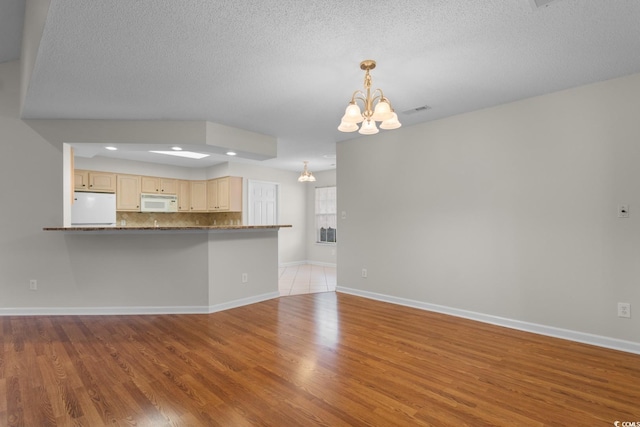 3107 Robyn Ct, Little River, SC 29566 - unfurnished living room with a chandelier, wood finished floors, baseboards, a textured ceiling, and recessed lighting