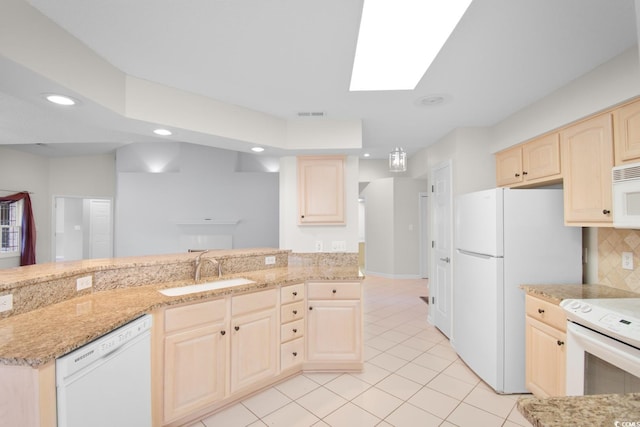 3107 Robyn Ct, Little River, SC 29566 - kitchen featuring white appliances, a sink, light brown cabinetry, recessed lighting, and a skylight