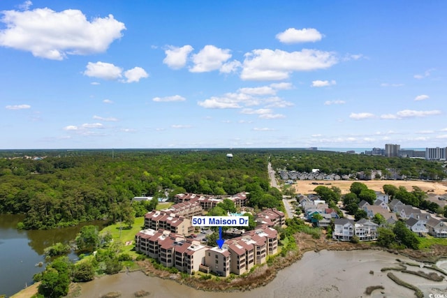 bird's eye view of a heavily wooded area and a large body of water