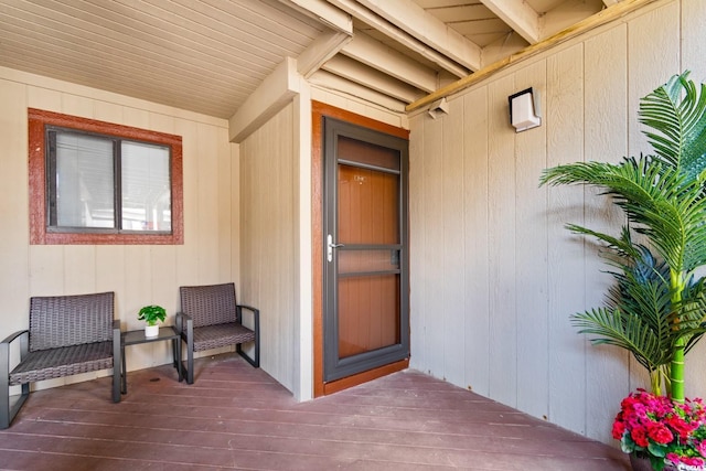 view of exterior entry with a wooden deck