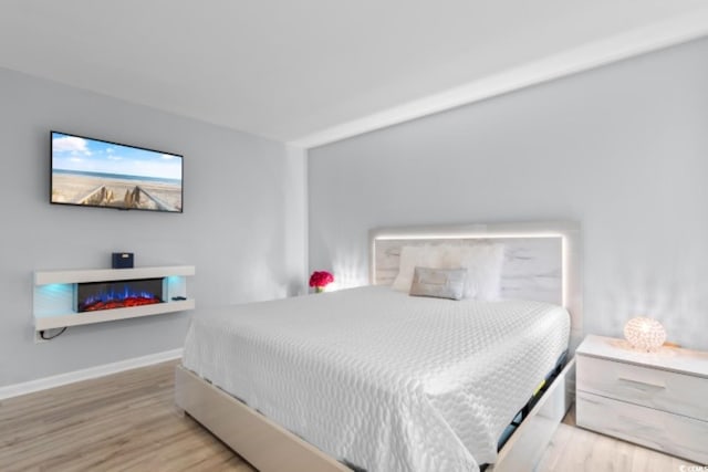 bedroom featuring wood finished floors and baseboards