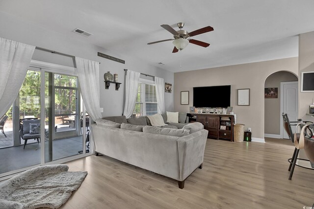 9232 Goodwill Ct, Myrtle Beach, SC 29579 - living room with a ceiling fan, light wood-type flooring, plenty of natural light, and arched walkways