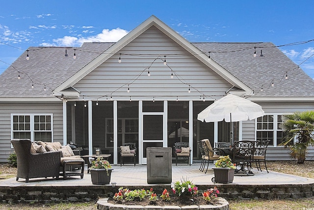 9232 Goodwill Ct, Myrtle Beach, SC 29579 - rear view of house with a shingled roof, a patio area, an outdoor living space, and a sunroom