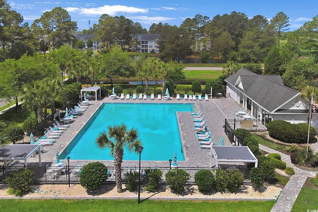 9232 Goodwill Ct, Myrtle Beach, SC 29579 - community pool featuring fence, view of wooded area, and a patio area