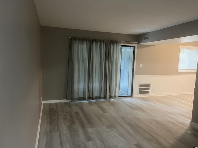 spare room featuring wood finished floors and baseboards