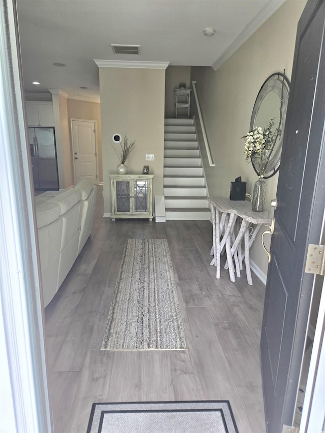 448 Papyrus Cir Unit 448, Little River, SC 29566 - foyer with ornamental molding, stairway, baseboards, and wood finished floors