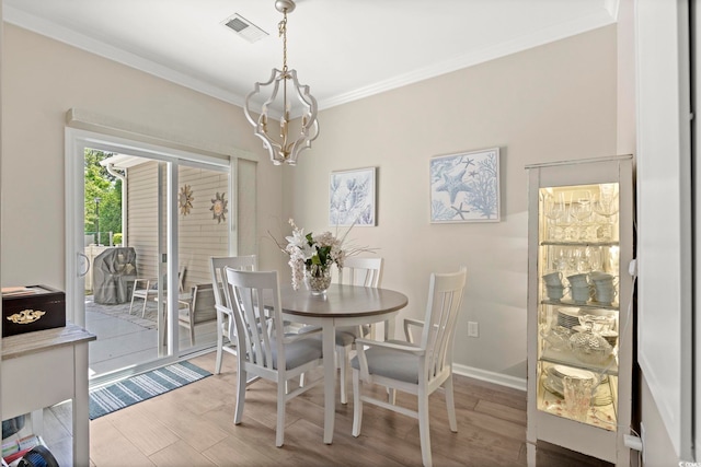 448 Papyrus Cir Unit 448, Little River, SC 29566 - dining area with a chandelier, crown molding, wood finished floors, and baseboards