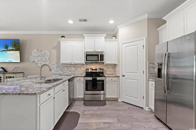 448 Papyrus Cir Unit 448, Little River, SC 29566 - kitchen with stainless steel appliances, a sink, a peninsula, ornamental molding, and white cabinetry