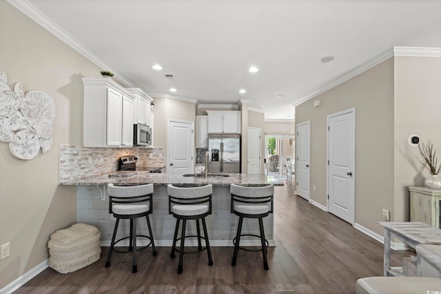 448 Papyrus Cir Unit 448, Little River, SC 29566 - kitchen featuring appliances with stainless steel finishes, a peninsula, white cabinets, light stone counters, and a sink