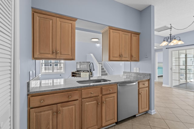 kitchen featuring dishwasher, a sink, light tile patterned flooring, stone countertops, and a chandelier