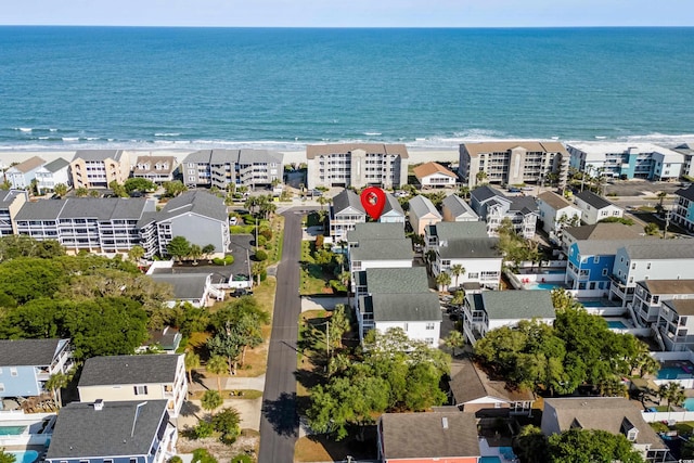 aerial perspective of suburban area featuring waterfront with a beach
