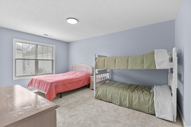 carpeted bedroom with a textured ceiling
