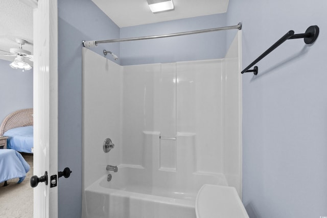 ensuite bathroom with ceiling fan and shower / washtub combination