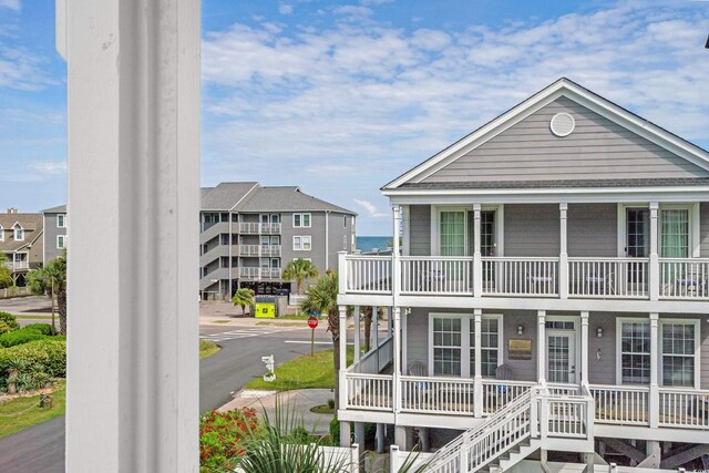 view of front of property with covered porch and a balcony