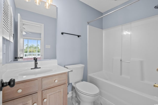 bathroom featuring toilet, vanity, and washtub / shower combination