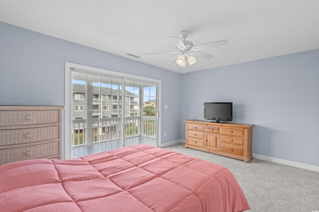 bedroom featuring access to exterior, baseboards, light colored carpet, ceiling fan, and a textured ceiling